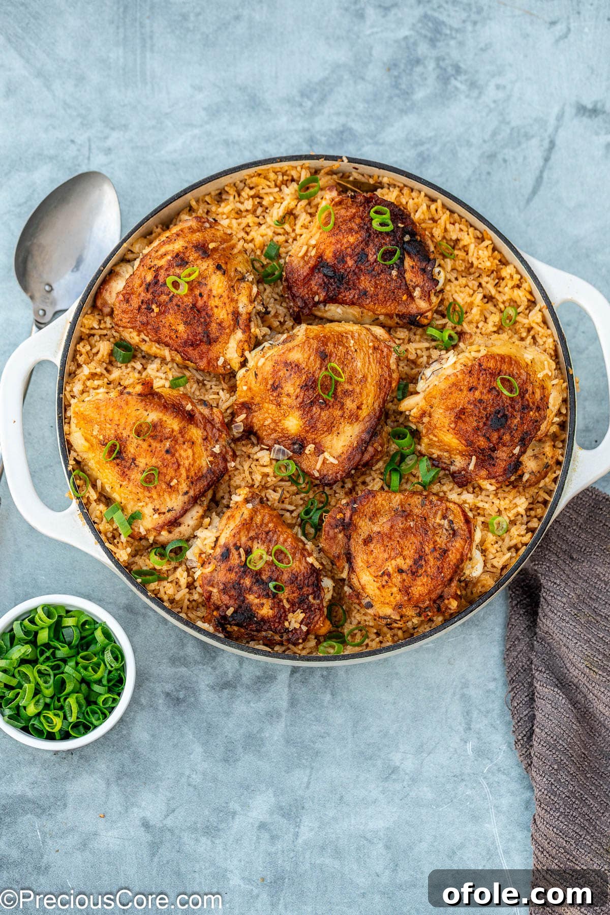 Savory One-Pot Chicken Thighs and Rice 12 The completed one pot chicken thighs and rice, garnished with fresh green onions, steaming and ready to enjoy.