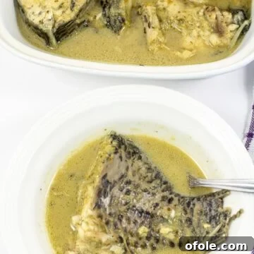Delicious Cameroonian Fish Pepper Soup with tilapia, fresh herbs, and spices, presented beautifully in a bowl.