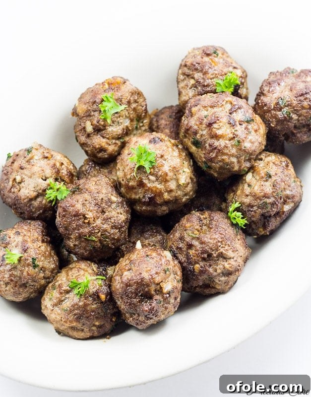 White dish of cooked meatballs.