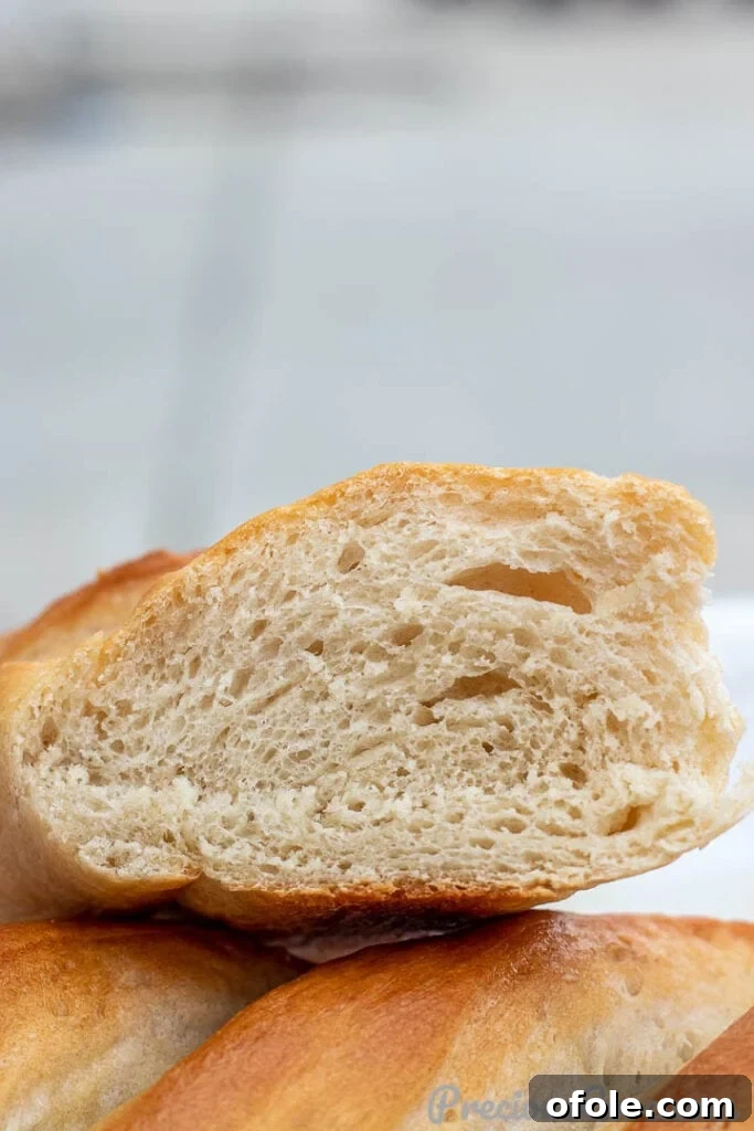 Effortless Crusty French Loaves 4 A freshly cut loaf of French Bread, revealing its airy, open crumb and tender texture