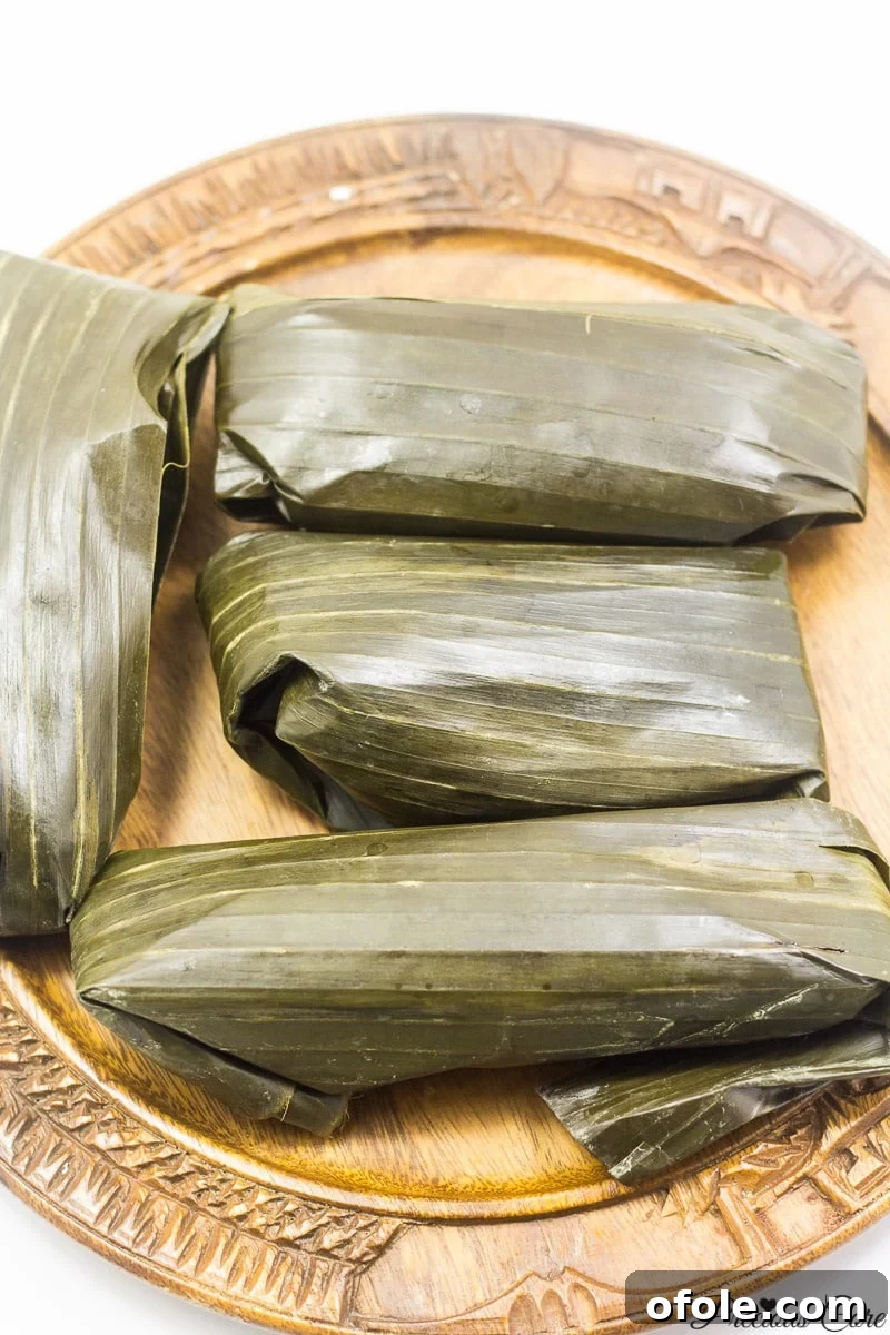 Savory Kwacoco and Palm Nut Soup 3 Cocoyam (macabo) paste wrapped in banana leaves, ready for steaming to make Kwacoco