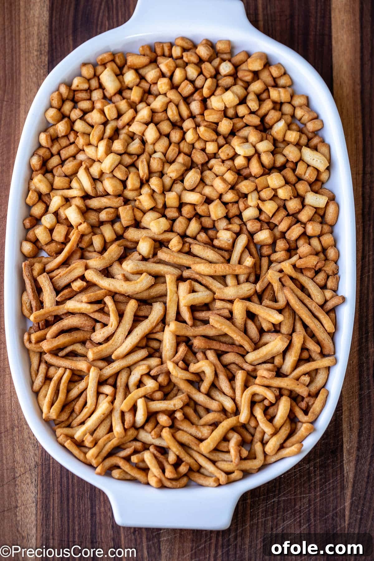 Crispy Chin Chin pieces displayed on a white tray, ready to be enjoyed.