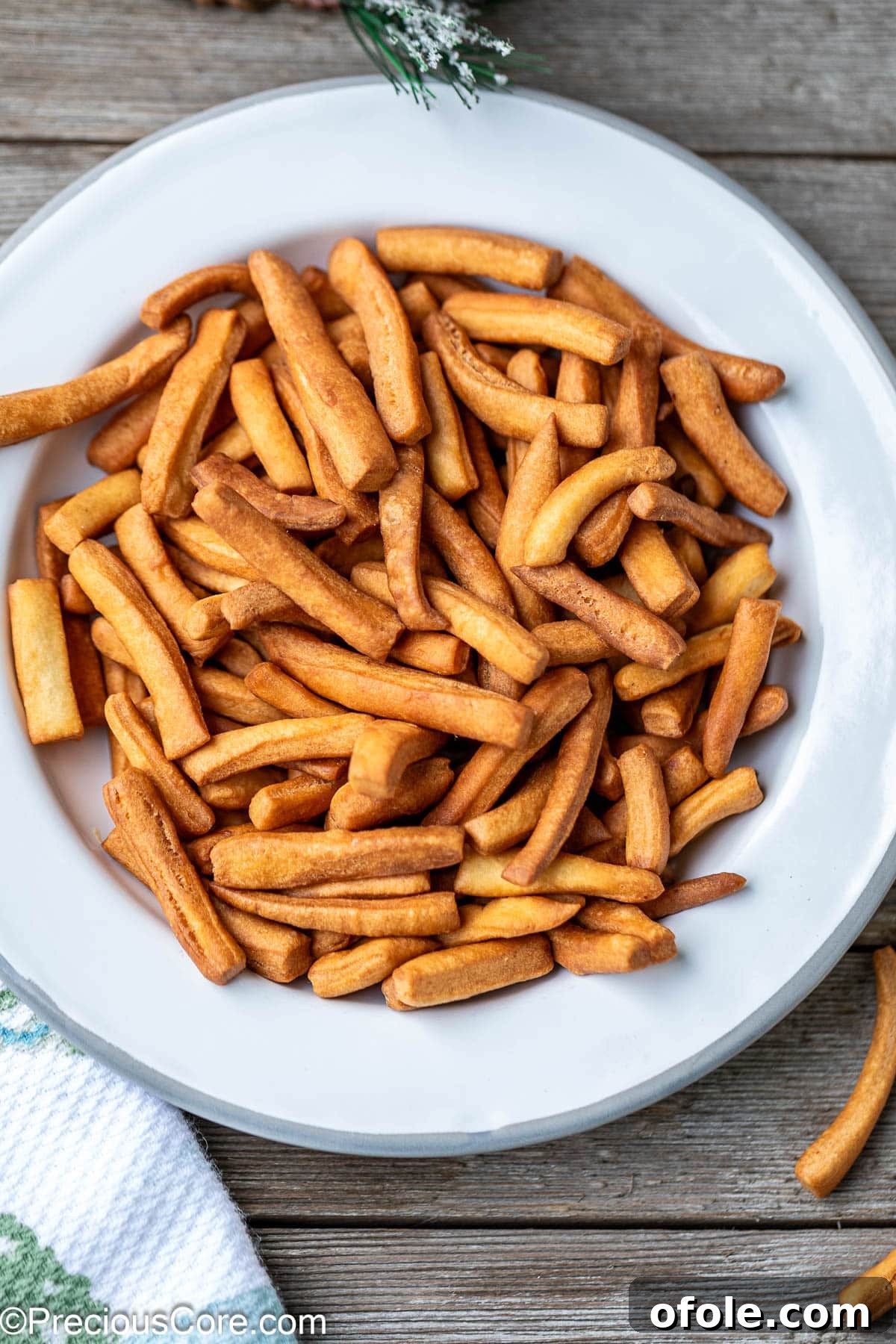 A generous serving of crispy Chin Chin elegantly arranged on a white plate.