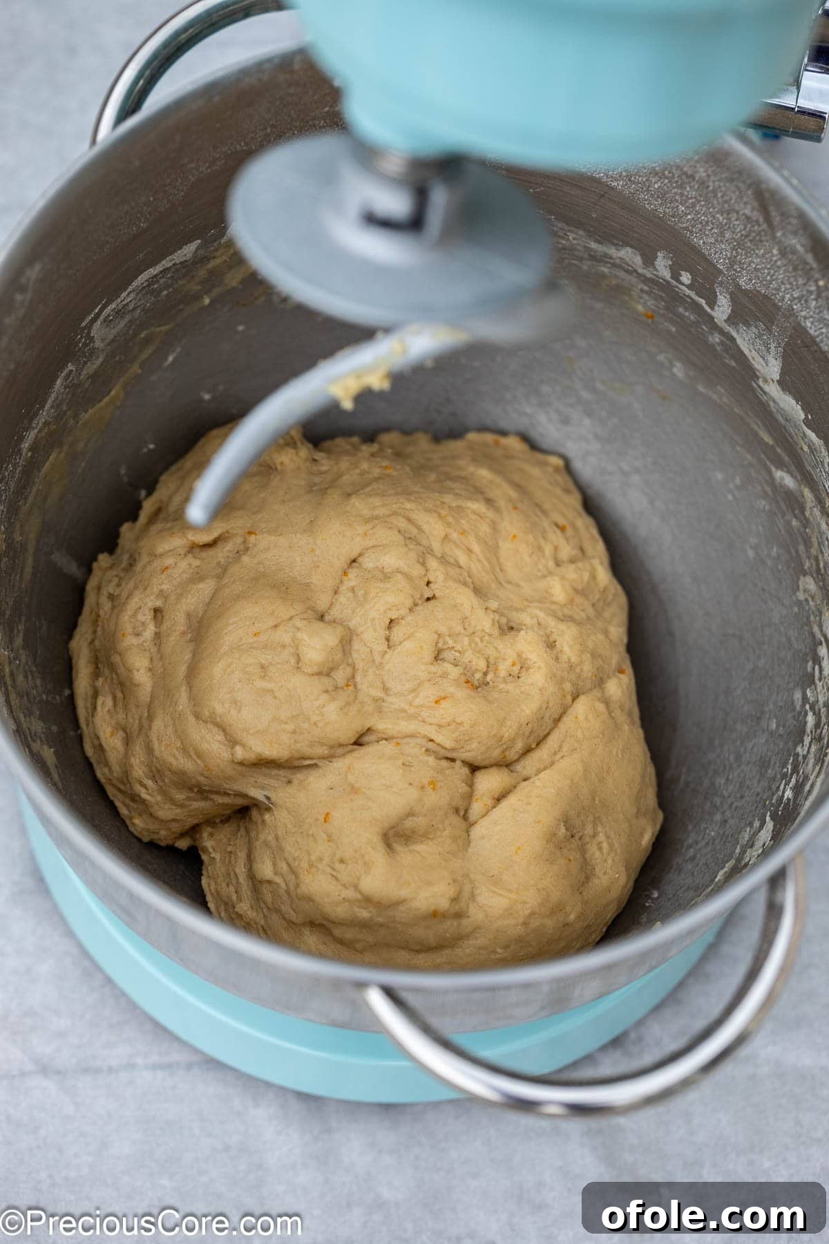 Freshly mixed Chin Chin dough in a stand mixer bowl, ready for the next step.