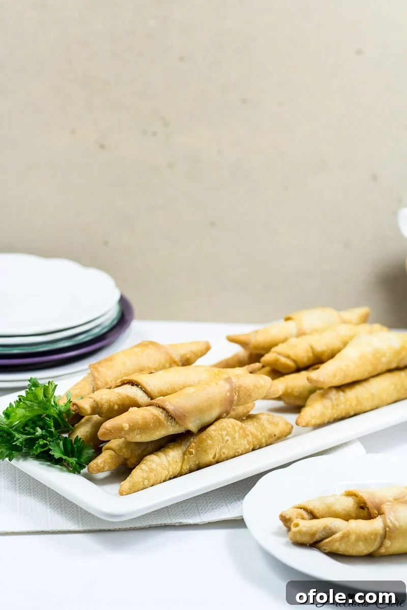 Crispy golden brown Cameroonian fish rolls on a plate