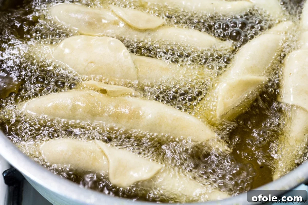 Fish rolls frying in hot oil until golden brown