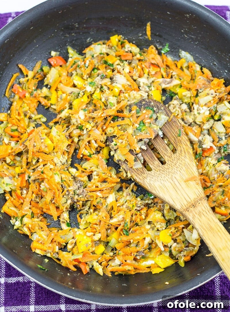 Cooking the sardine and vegetable filling for fish rolls