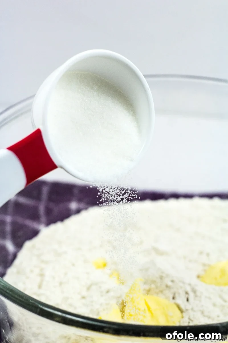 Adding sugar to the fish roll dough mixture