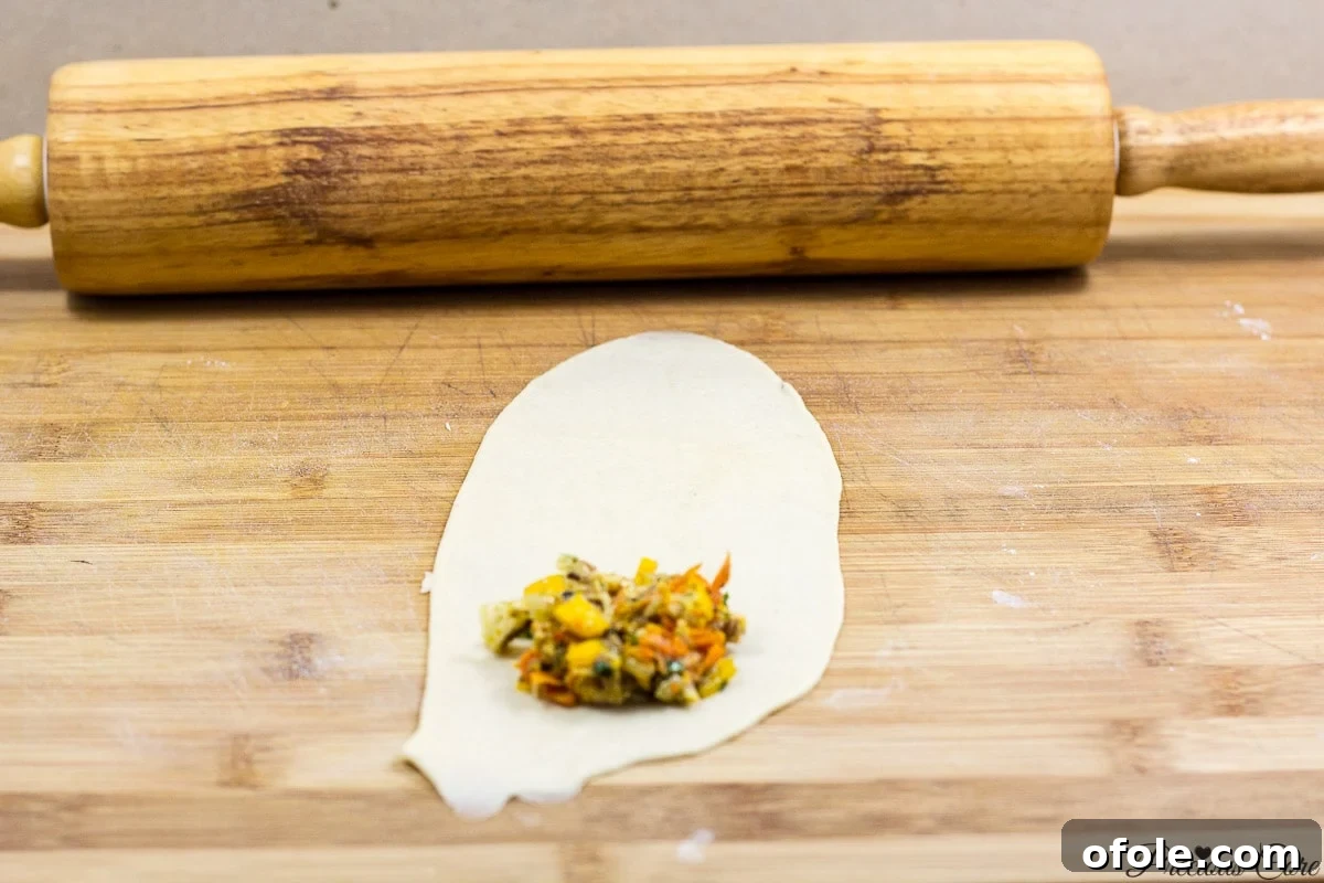 Rolling out fish roll dough into an oval shape