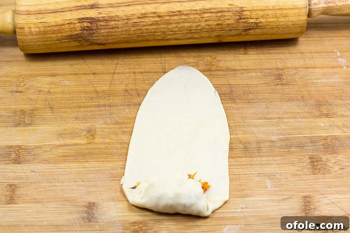 Folding the dough over the fish filling