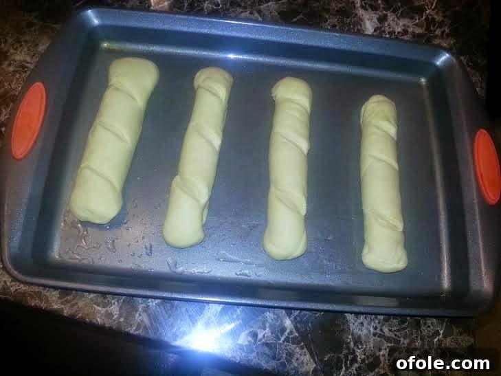 Milk Bread Loaves on Baking Tray Multiple shaped dough loaves placed on a baking tray, ready for the second rise.