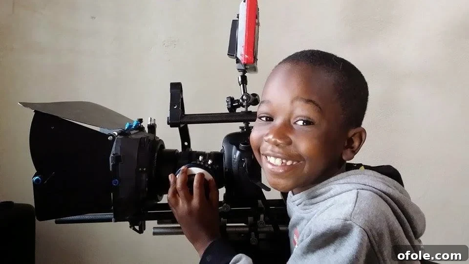 Penjo Baba's sons playing with cameras, hinting at future photographers