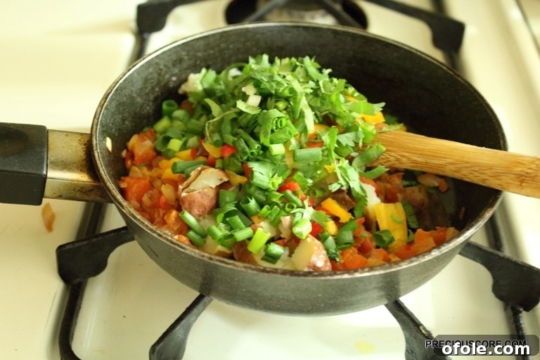 Hearty Breakfast Frittata 9 A vibrant mix of chopped vegetables in a skillet, ready for the egg mixture