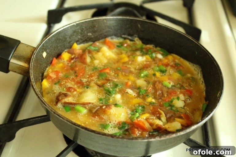 Hearty Breakfast Frittata 10 Egg mixture poured over the sautéed vegetables in an oven-proof skillet