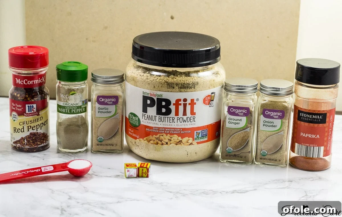 A selection of fresh spices and ingredients for making homemade suya seasoning.