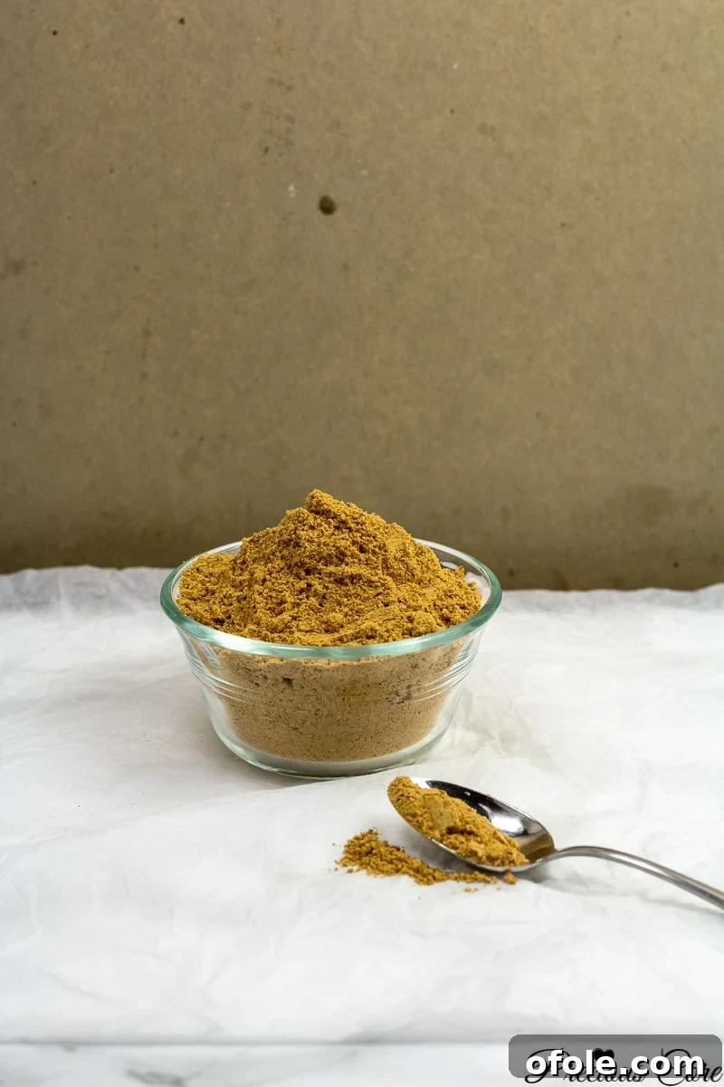 Close-up of a homemade Nigerian suya spice blend, showcasing its vibrant color and finely ground texture.