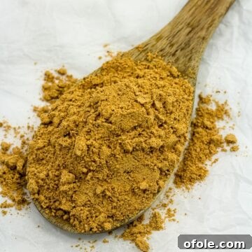 Suya spice on a wooden spoon.
