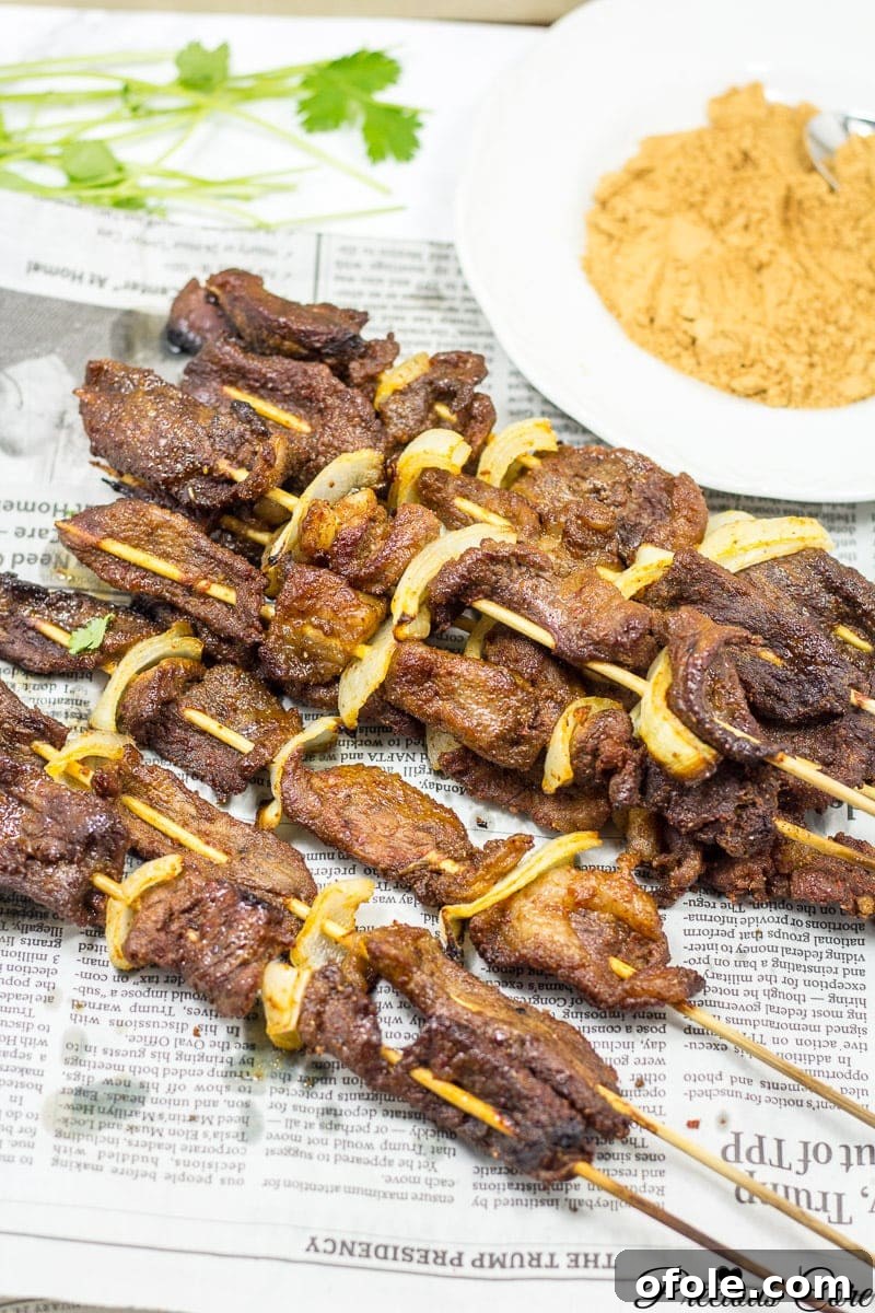 The Secret to Perfect Beef Suya: Homemade Suya Spice Blend 2 Delicious Beef Suya skewers, a traditional West African grilled meat street food.