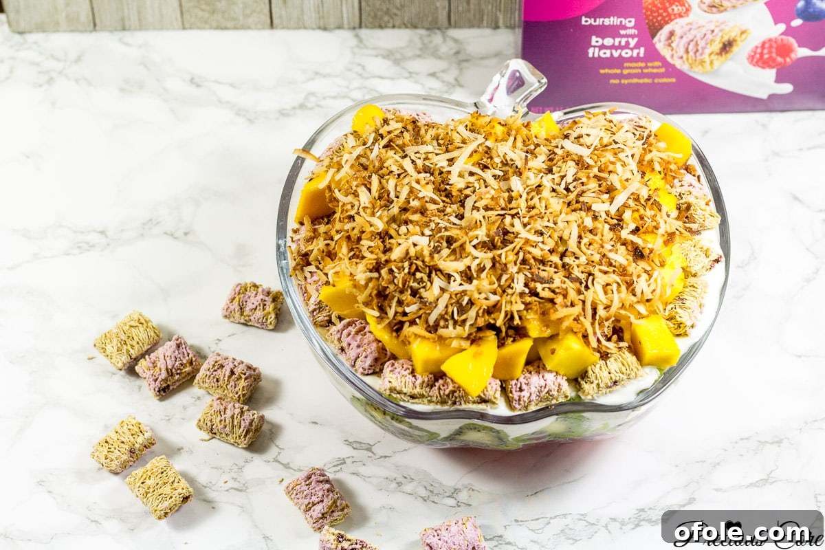 Vibrant Seven Layer Fruit Stack 12 The final layer of mango and coconut for the 7 layer fruit salad, ready to be served and enjoyed during summer.