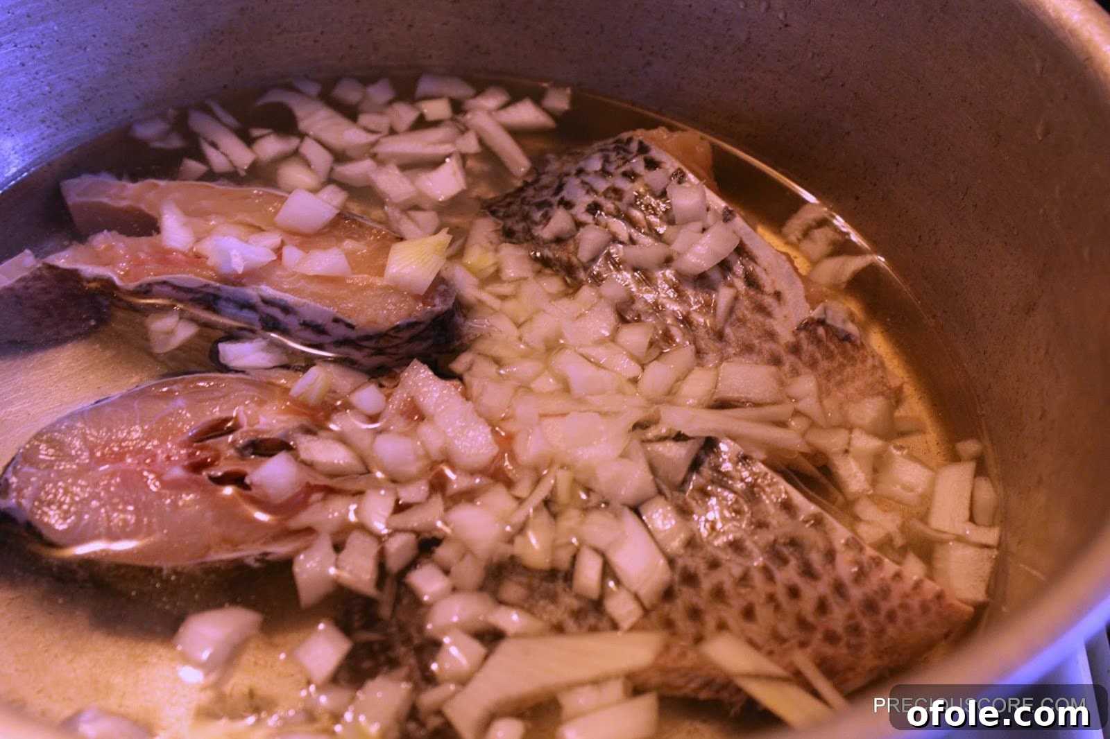Effortless Okra Delight 6 Tilapia Fish Simmering with Chopped Onions and Water