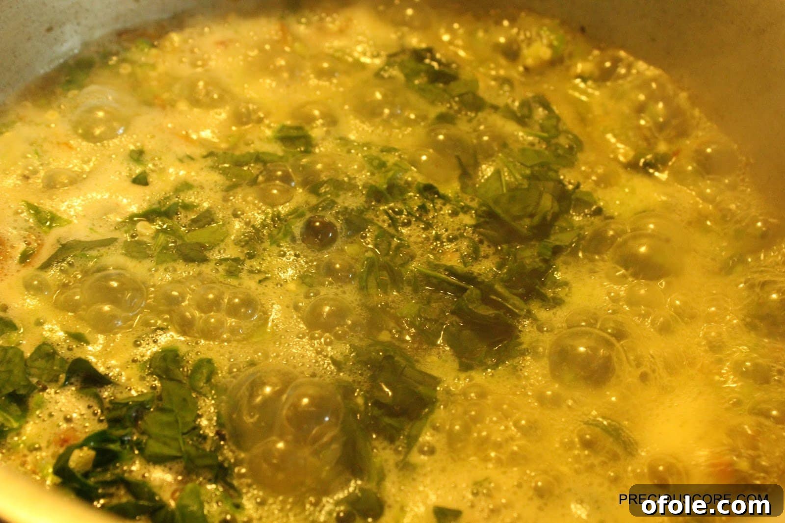 Effortless Okra Delight 8 Freshly Chopped Spinach Being Added to Okra Soup