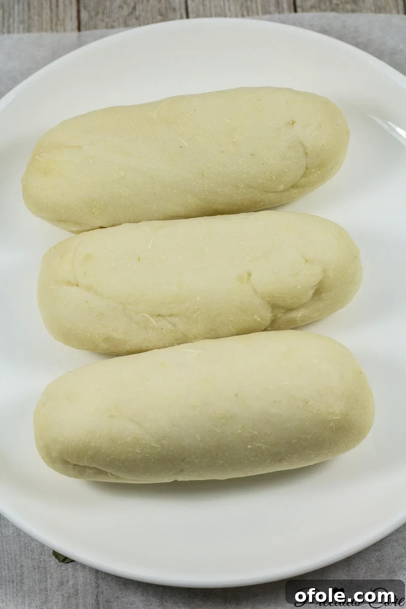 Close-up of freshly prepared water fufu, also known as cassava fufu, showcasing its smooth, off-white, and pliable texture.