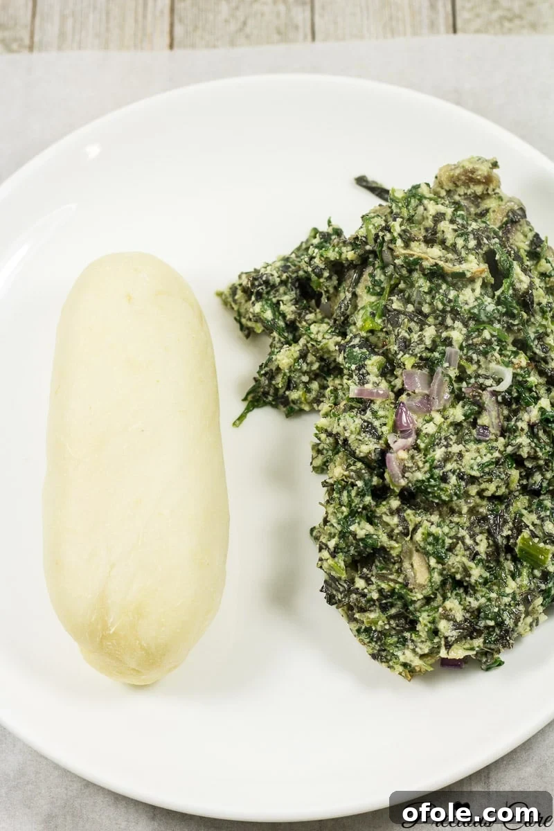 A serving of Water Fufu alongside a delicious bowl of Ndole stew, showcasing a popular Cameroonian food pairing.