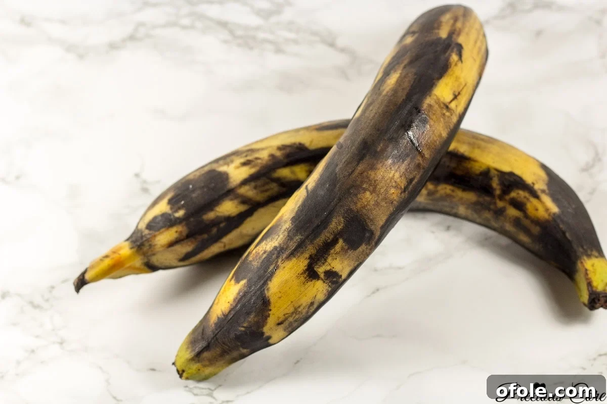 Very brown plantains on a marbled countertop.