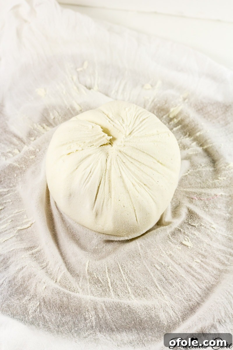 Close-up of the straining process, showing corn flour paste being sieved to separate starch from any remaining fibers.