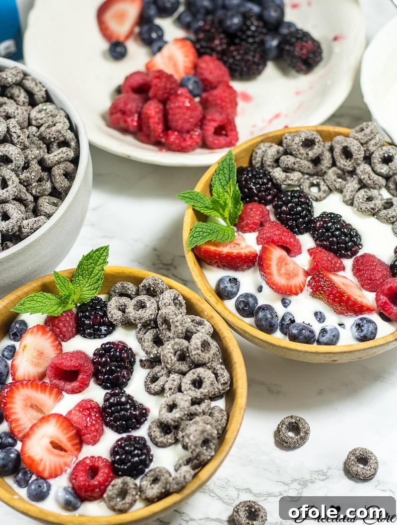 Fast & Fresh Berry Parfait for Busy Mornings 3 Two vibrant mixed berry parfait bowls, ready to be enjoyed.