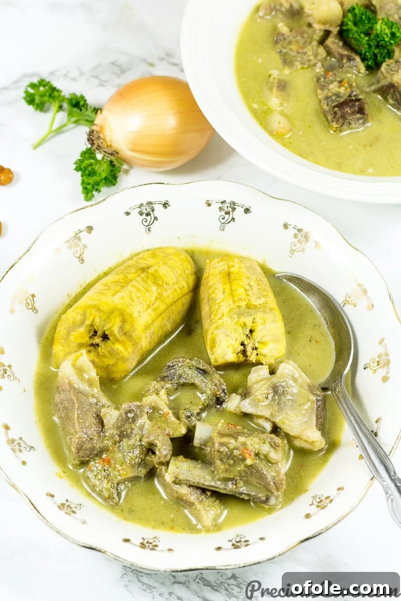 Fiery Goat Pepper Soup 6 Goat Meat Pepper Soup served alongside boiled plantain slices.