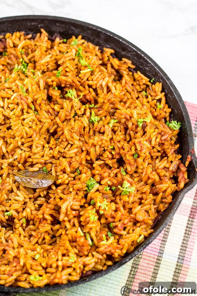 Easy Oven Baked Jollof Rice 4 Easy Jollof Rice being cooked in an oven-safe pot.