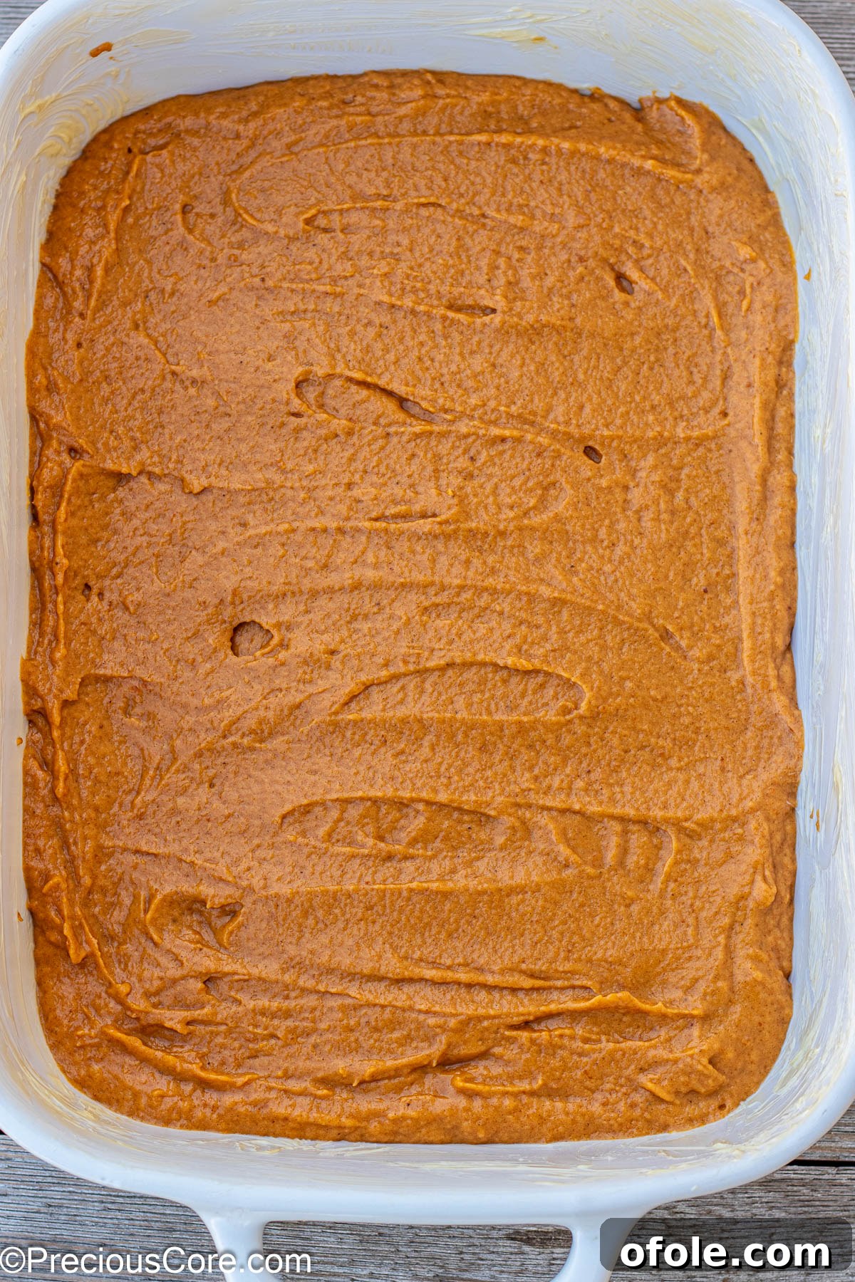 Spiced Pumpkin Cake with Luscious Cream Cheese Frosting 4 Pumpkin cake batter evenly spread in a 9 by 13 inch baking pan, ready for the oven.