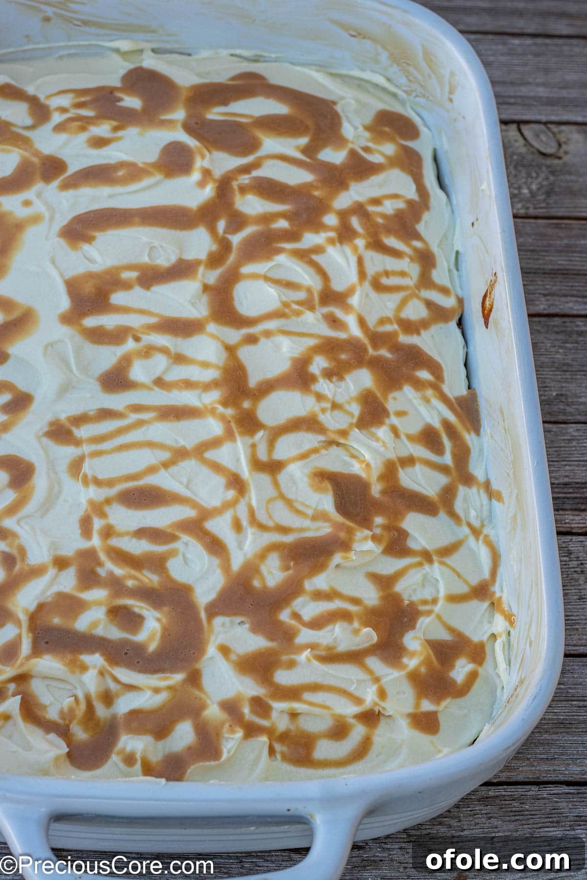 Spiced Pumpkin Cake with Luscious Cream Cheese Frosting 7 Golden caramel sauce artfully drizzled on top of a smooth cream cheese frosted pumpkin cake.
