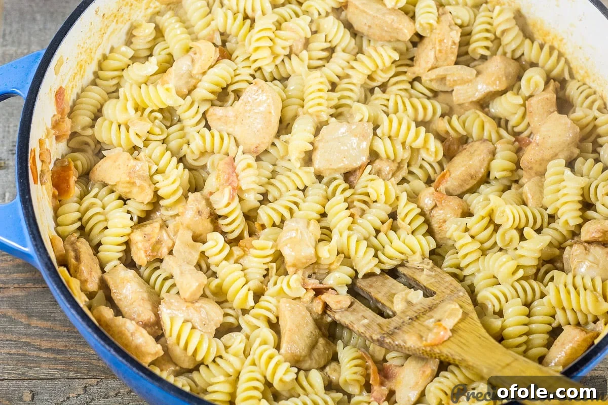 Velvety One Pot Chicken Macaroni 11 Macaroni and Chicken dinner recipe step 7 - Mixing all ingredients for creamy goodness