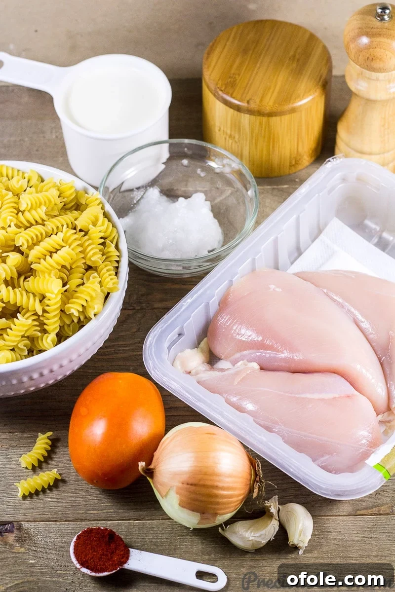 Easy Creamy One-Pot Chicken Macaroni 4 Macaroni and Chicken dinner recipe ingredients on a cutting board