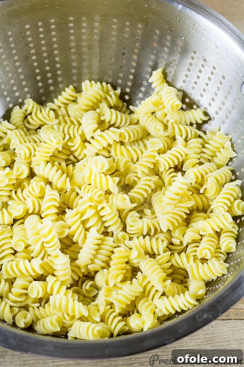Velvety One Pot Chicken Macaroni 5 Macaroni and Chicken dinner recipe step 1 - Boiling pasta and reserving water for sauce