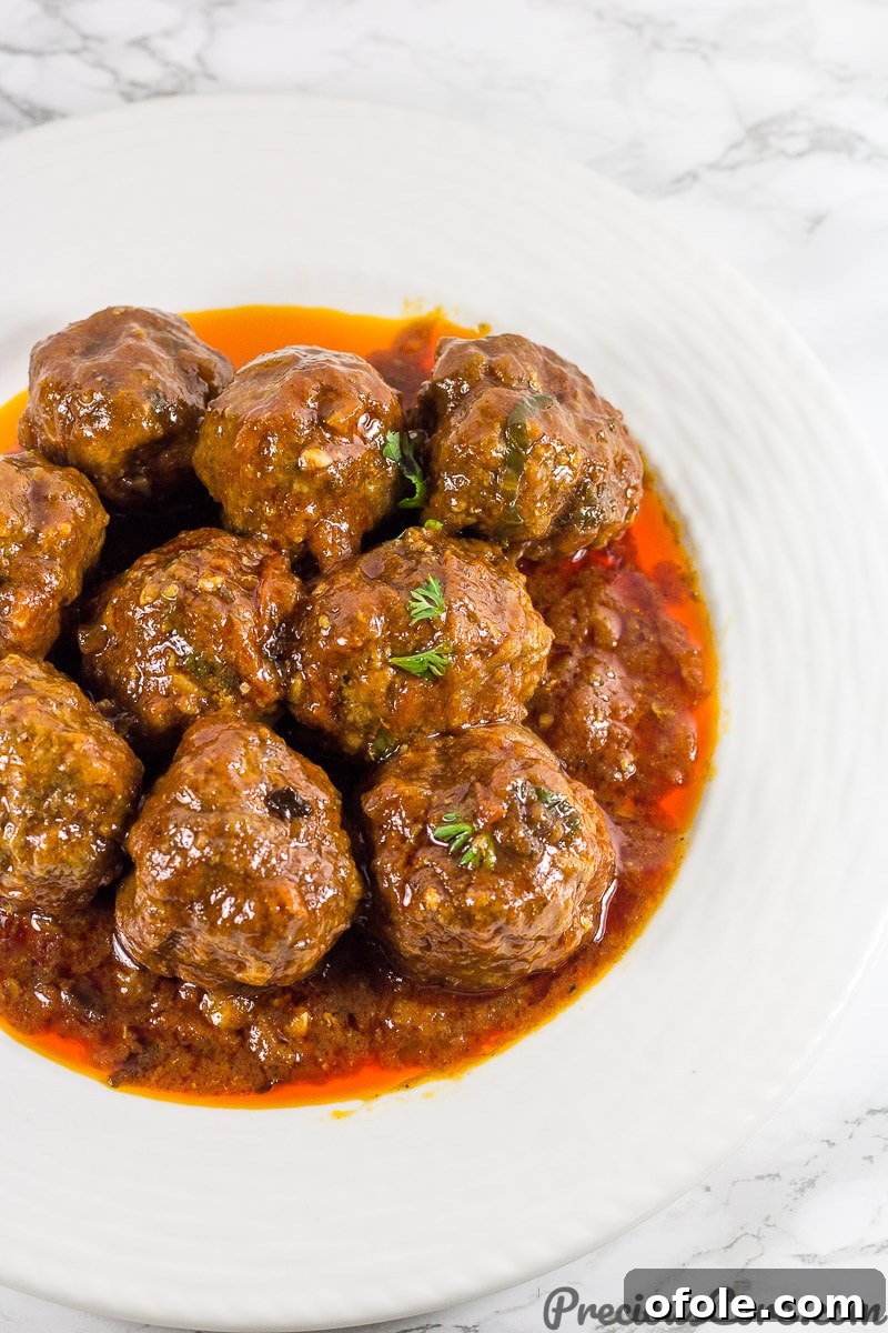 Delicious African Meatballs simmering in a rich, red tomato sauce, perfect for a hearty dinner.