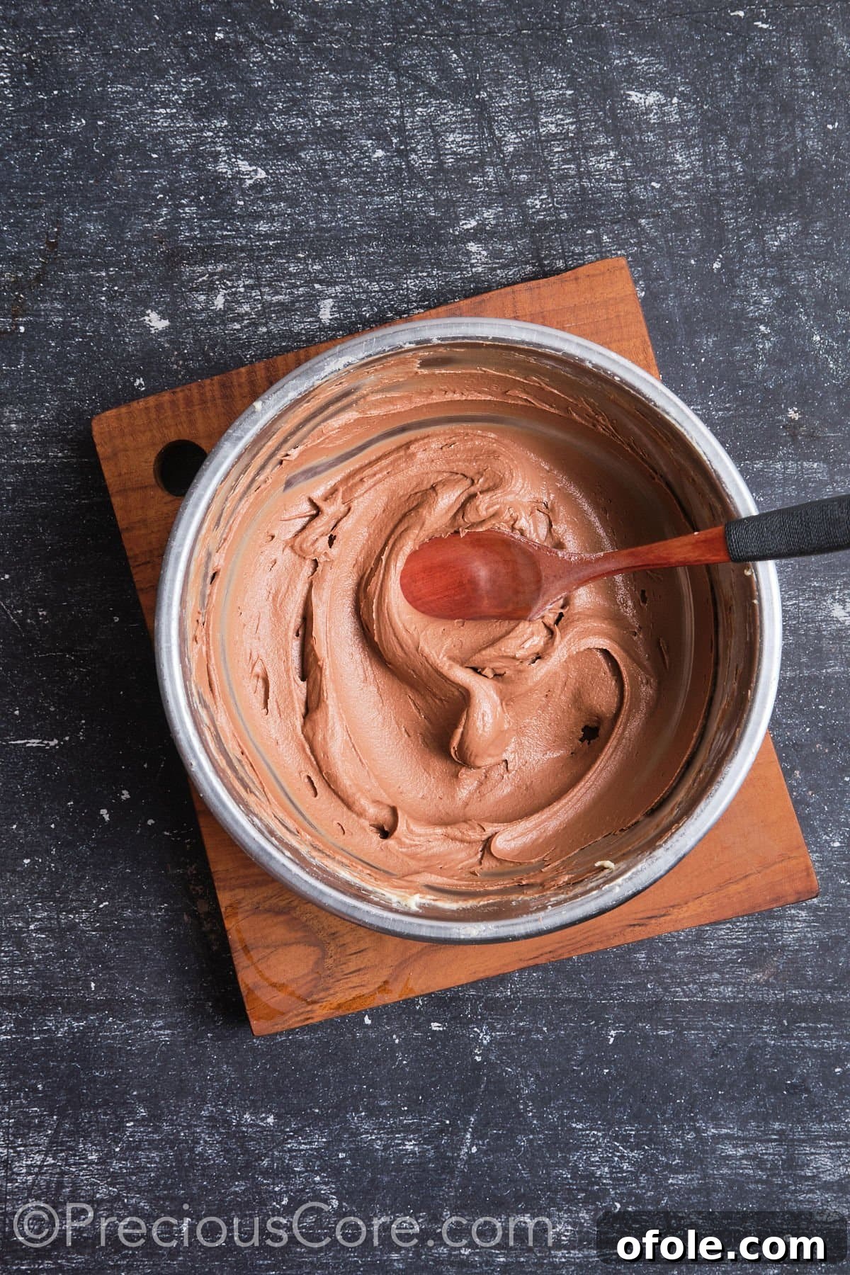 Decadent Double Chocolate Cupcakes 16 Smooth and rich whipped chocolate frosting in a mixing bowl, ready for piping.