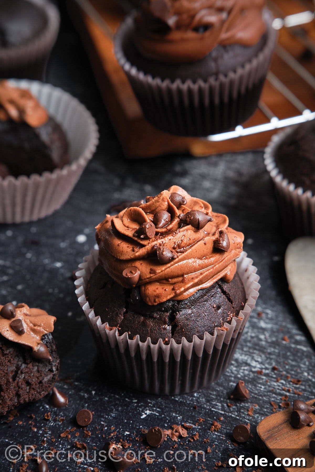 Decadent Chocolate Cupcakes 18 A perfectly frosted chocolate cupcake, topped with additional chocolate chips for extra indulgence.