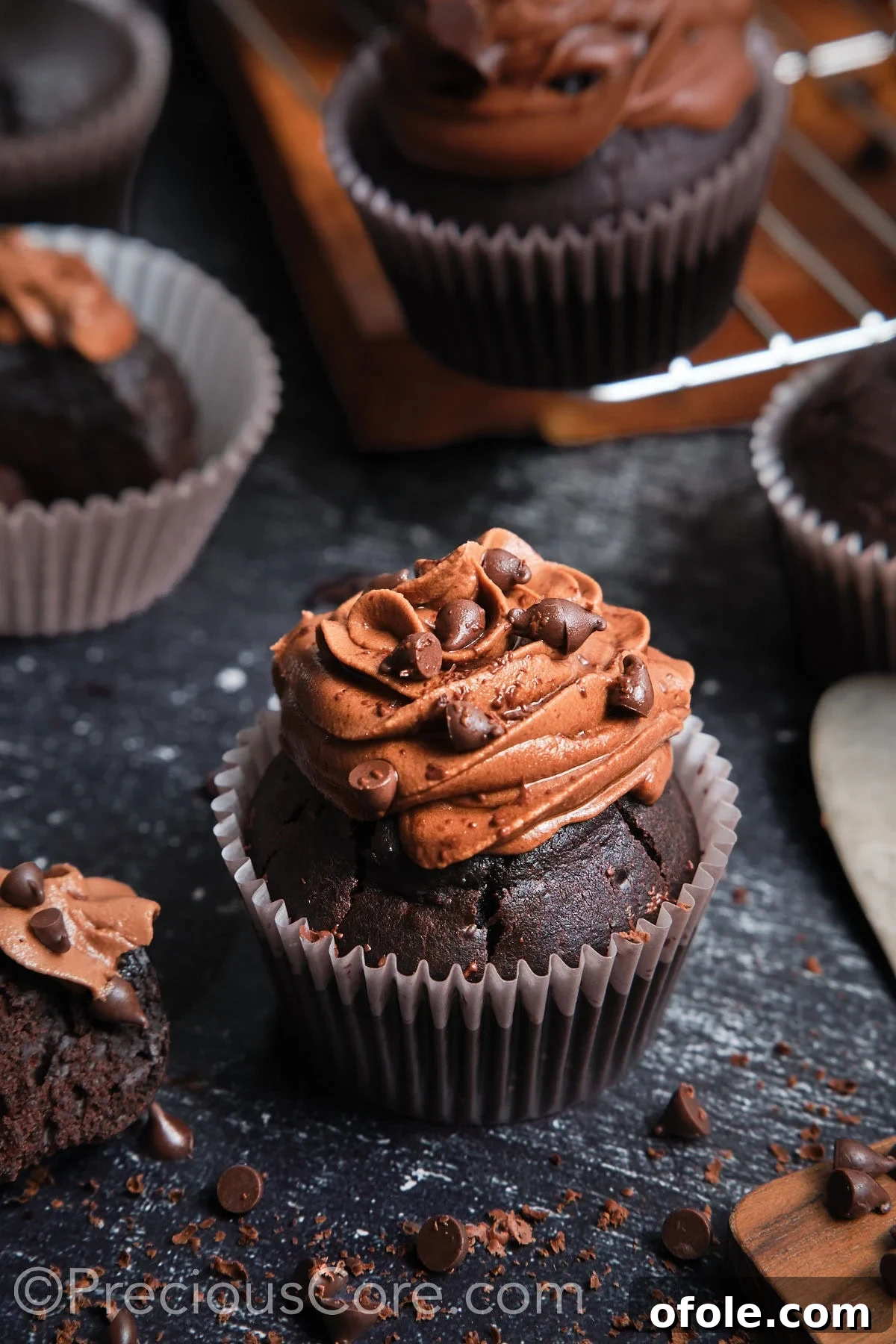 Decadent Double Chocolate Cupcakes 18 A beautifully frosted chocolate cupcake topped with chocolate chips, ready to be served.