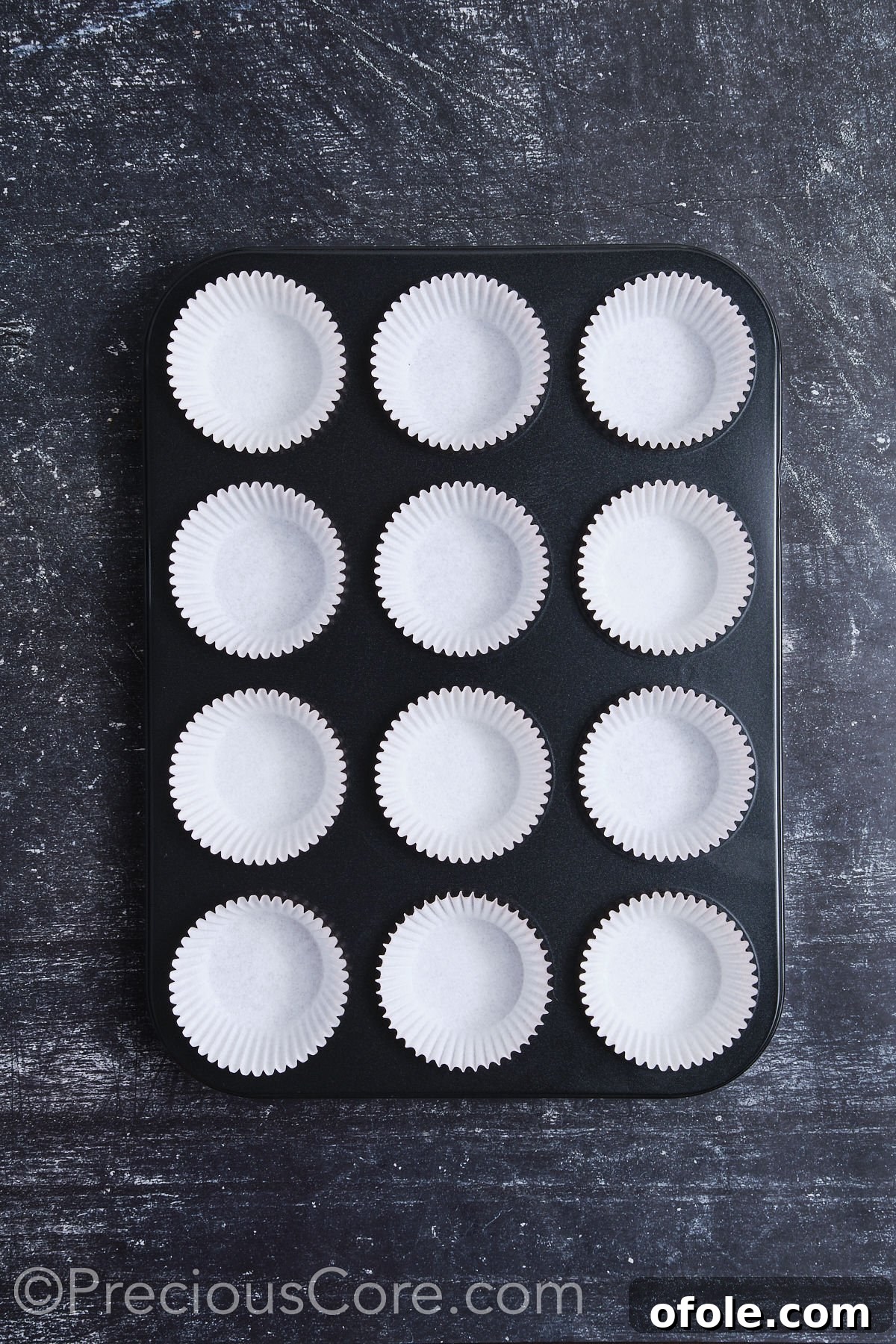 Decadent Chocolate Cupcakes 7 A muffin pan fully lined with cupcake liners, demonstrating organized preparation for baking.