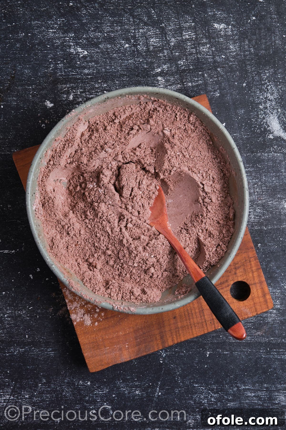 Decadent Double Chocolate Cupcakes 9 Thoroughly whisked dry ingredients in a mixing bowl, showing a consistent brown color.