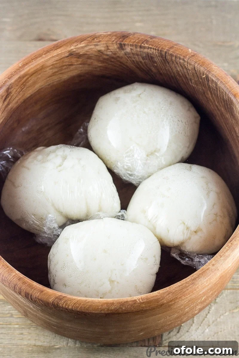 How to Make Fufu Corn 2 Wrapped corn fufu in a wooden bowl, ready to be served or stored.