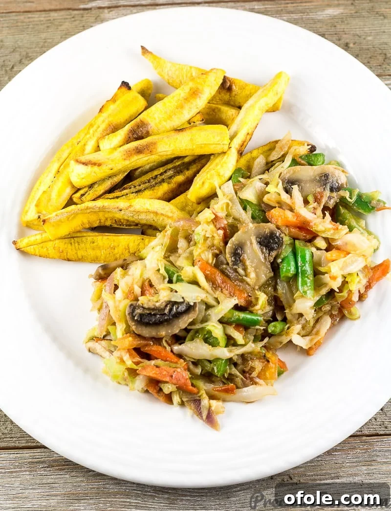 Cameroon Cabbage Stew and Plantains. A delicious and healthy vegan African mixed vegetables with cabbage dish served alongside golden plantain fries.