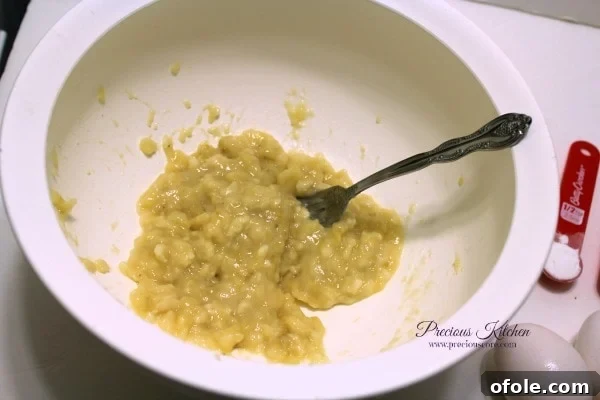 Mash Bananas Mashing ripe bananas for pancake batter