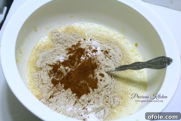Add Dry Ingredients Adding dry ingredients to banana pancake batter