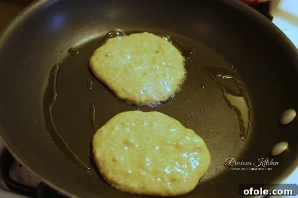 Cooking Pancakes Cooking banana pancake batter on a frying pan
