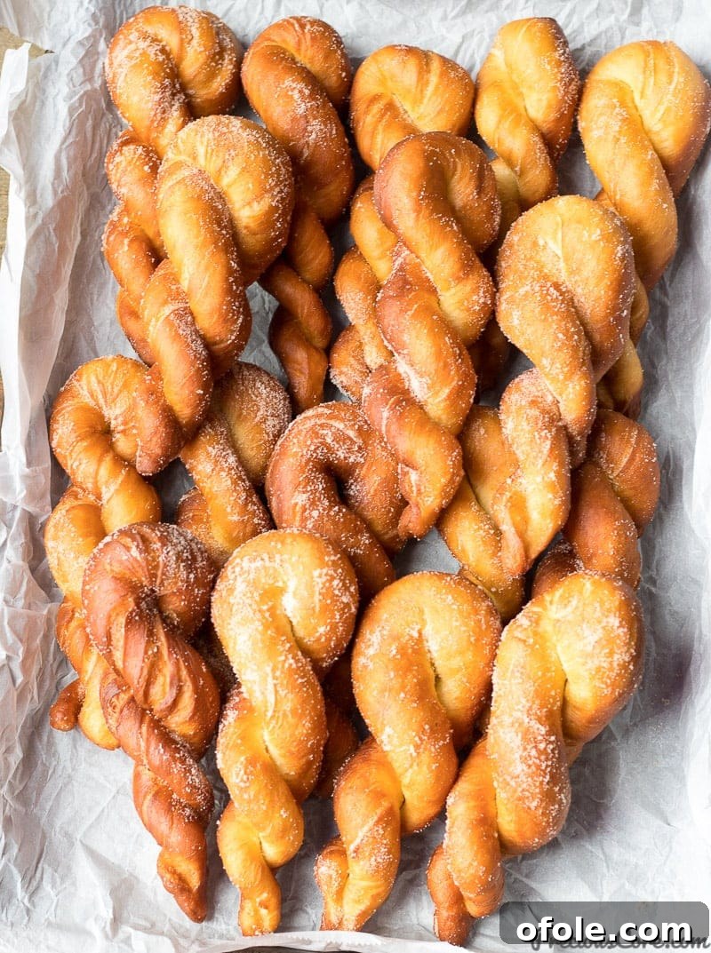 Warm, golden-brown African twisted doughnuts on a serving plate.