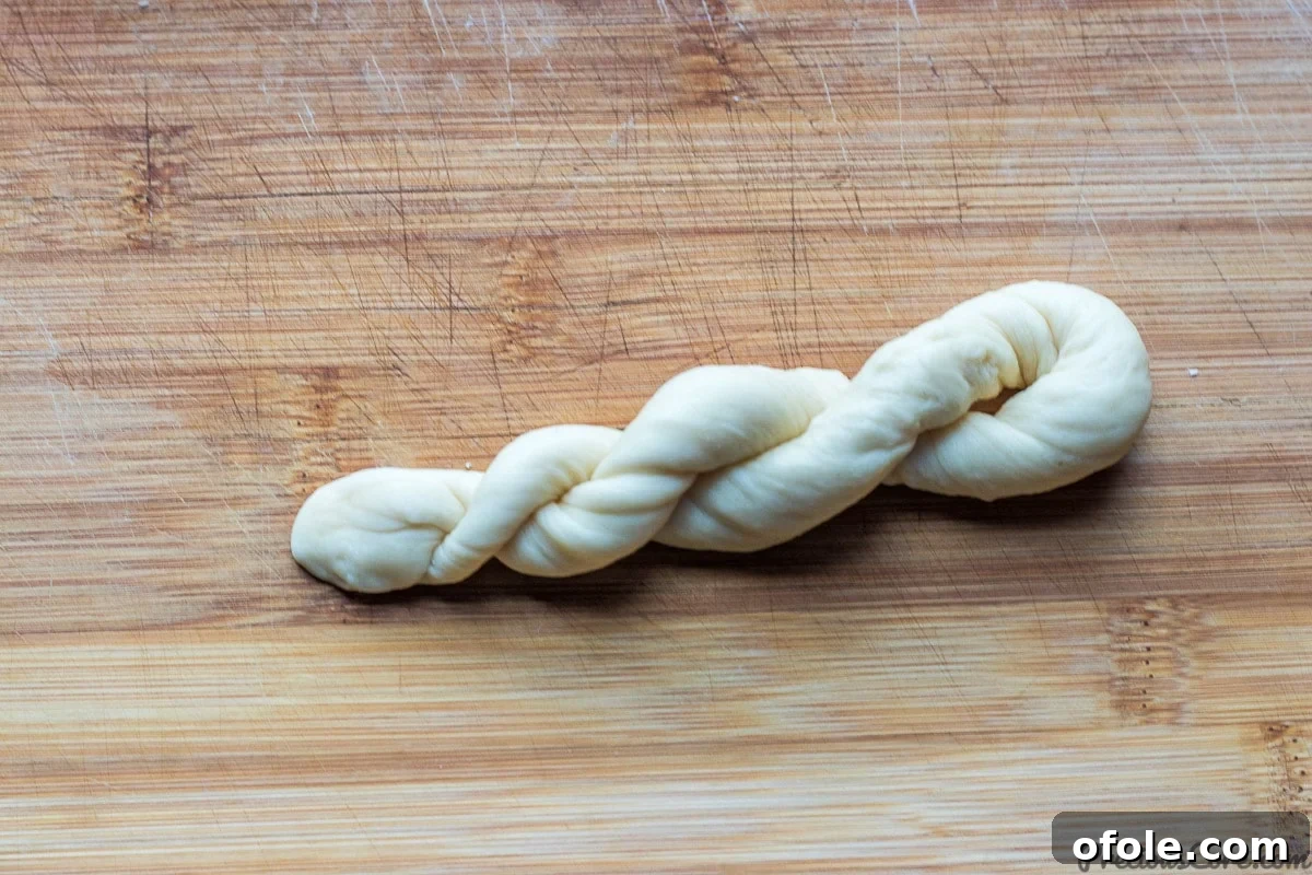 A perfectly formed twisted doughnut, ready for the frying process.